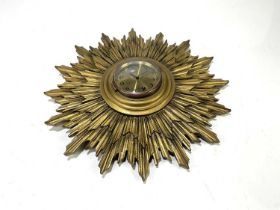 A gilt painted wooden sun clock, with brass dial set with Arabic numerals, 40cm.