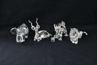 SWAROVSKI; four crystal figures including lion from the 1995 'Inspiration Africa' series, elephant