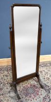 A 1930s mahogany framed cheval mirror with mirror plate, on brass castors, height 161cm.