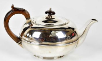 WILLIAM EATON; a George III hallmarked silver teapot of squat circular form with turned finial,