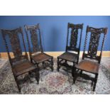 Four carved oak hall chairs with panelled seats (4).