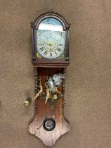 A circa 1900 Dutch oak wall clock with painted dial, winged finials and shaped case, height