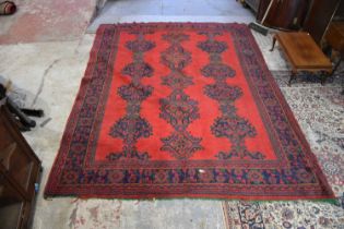 A large Turkish carpet, with stylised decoration on a red ground, approx 254 x 330cm.