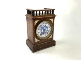 A 19th century oak cased Aesthetic Movement French mantel clock with blue and white enamelled dial