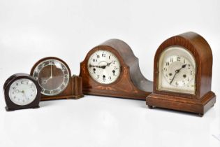 An early 20th century oak cased lancet top mantel clock, the silvered dial set with Arabic numerals,