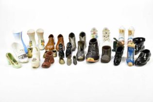 A collection of ceramic and metal novelty models of shoes including North Pier Blackpool crested