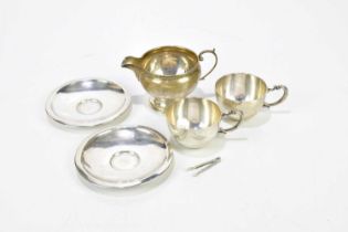 ROBERTS & DORE; a George V hallmarked silver cream jug, Birmingham 1921 and two 916 grade silver