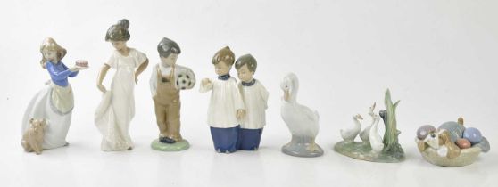 NAO; four figures and three models including a boy standing holding a football, height 19cm, a
