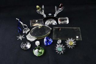 SWAROVSKI; a large collection of glass sculptures, figures, Swarovski stands and plaques.