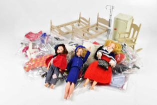A collection of dolls including a Sindy example and assorted clothing, together with a small