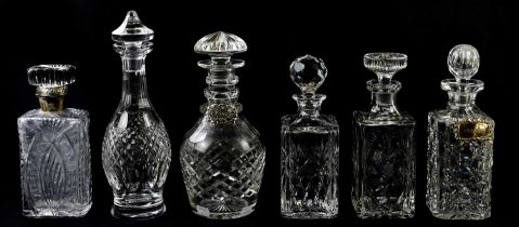 Six cut glass decanters including an example with Continental silver collar of rectangular form, two