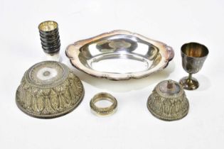 A collection of white metal items including six tot cups, an Eastern bowl, a shaped bowl, etc,