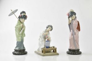 LLADRÓ; three models of Geisha girls including a figure of a kneeling Geisha with prunus flowers,