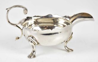 WILLIAM JUSTUS; a George II hallmarked silver sauceboat of oval form on three hoof feet, London