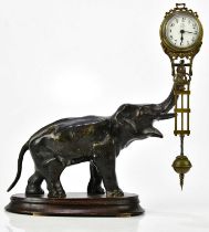 A bronze spelter mystery clock modelled as an elephant supporting the rotating timepiece, on