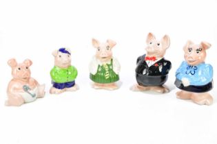 WADE; a family of Nat West pig money banks and a similar later example, Cousin Wesley.