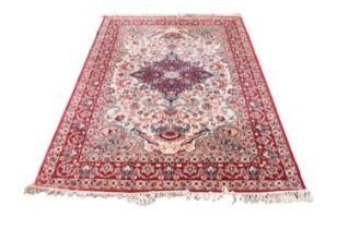 A machine woven carpet, worked with a floral pattern against a red and pale cream ground, 236 x