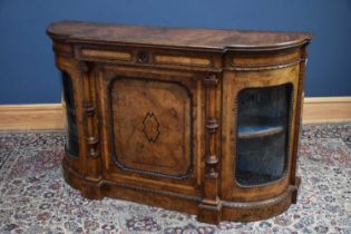 A Victorian walnut and ebonised credenza, with beaded decoration above a panel door flanked by