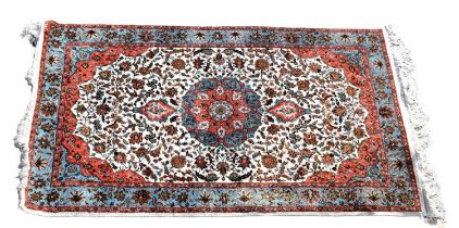 A Persian designed floral rug with multi-pattern design on a cream ground with stylised border,