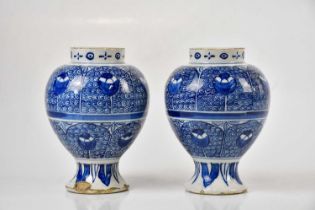 A pair of 19th century Delft baluster vases, height 20cm. Condition Report: Chips, crazing and