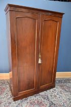A 20th century two door mahogany cupboard, with fitted shelves, height 205cm, width 120cm, depth