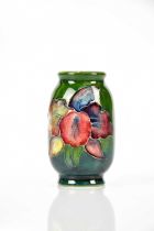 WALTER MOORCROFT; a miniature vase in the 'Orchid' pattern, printed marks, height 5cm. Condition