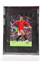 ERIC CANTONA; an autographed image of Eric in a Manchester United jersey, 29.5 x 19.5cm, framed