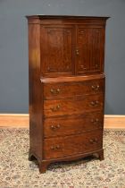 A 1920s mahogany bowfront cocktail cabinet, with two cupboard doors above four graduated drawers, on