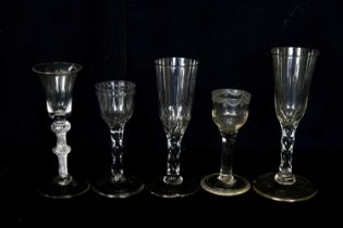Five 19th century and later wine glasses including an example with bell shaped bowl on a double knop