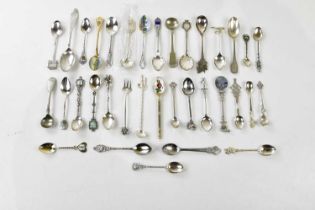 A collection of silver plate and white metal souvenir spoons.