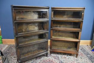 A pair of Globe Wernicke style metal bound four tier stacking bookcases with up and over doors,