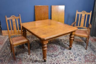A circa 1900 light oak wind out extending dining table with two additional leaves, on turned