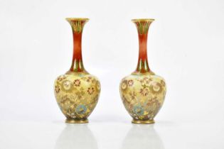 DOULTON LAMBETH; a pair of Artware vases with floral decoration and flared necks, height 26cm (2).