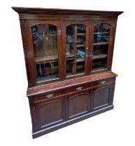 A Victorian mahogany bookcase with moulded cornice above three glazed doors, three drawers and three
