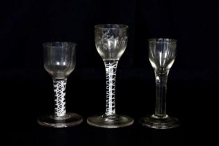 A 19th century wine glass with opaque air twist stem and large foot, height 11cm, a further opaque