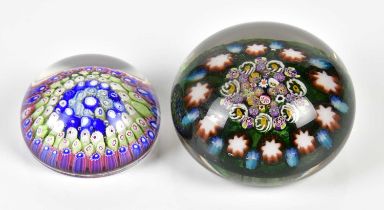 A 19th century millefiori decorated paperweight, diameter 6cm and a later paperweight with close