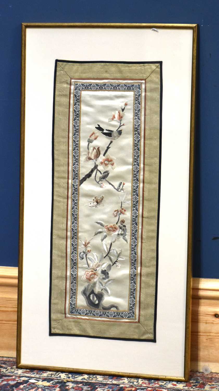 A 20th century Chinese silk panel decorated with birds perching with floral sprays, 63cm x 25cm,