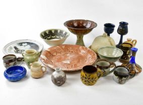 A collection of decorative and studio pottery including cups, chargers, jugs and bowls.