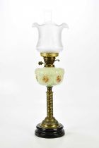 A Victorian oil lamp with associated frosted glass shade, the painted glass reservoir on turned