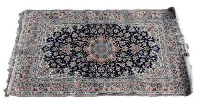 A Persian designed rug with floral motifs on a cream, blue and beige ground, 177 x 108cm.