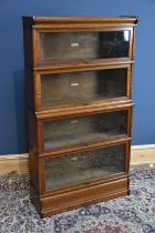 GLOBE WERNICKE CO LTD OFFICE & LIBRARY FURNISHERS, LONDON; an oak metal bound four tier bookcase