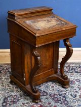 A Victorian walnut Davenport, with side door enclosing drawers, on carved cabriole front support,