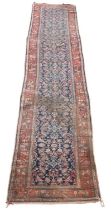 A Caucasian handwoven wool runner, c1900, worked with an allover floral design against a blue
