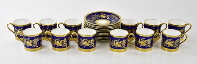 MINTON; a set of twelve blue and gilt coffee cups and saucers, with raised floral gilt detailing, (