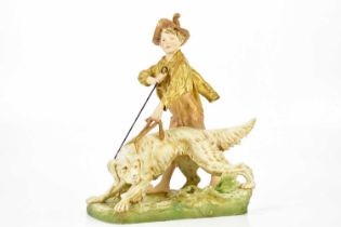 ROYAL DUX; a large and impressive figure of a boy walking a dog, height 45cm, length 37cm. Condition