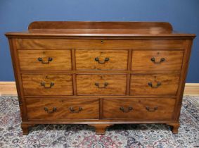 A 19th century mahogany mule chest with hinged cover above an arrangement of eight dummy and