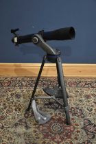 MEADE; a modern telescope on tripod stand.