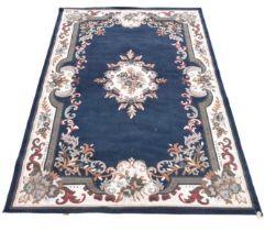 A machine woven carpet, worked with a central foliate medallion against a blue ground, 324 x 225cm.
