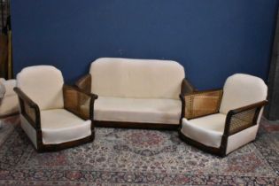 A three piece Bergere suite with cream cushions and upholstery.