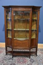 An Edwardian inlaid mahogany display cabinet with shaped top above the single glazed panel door